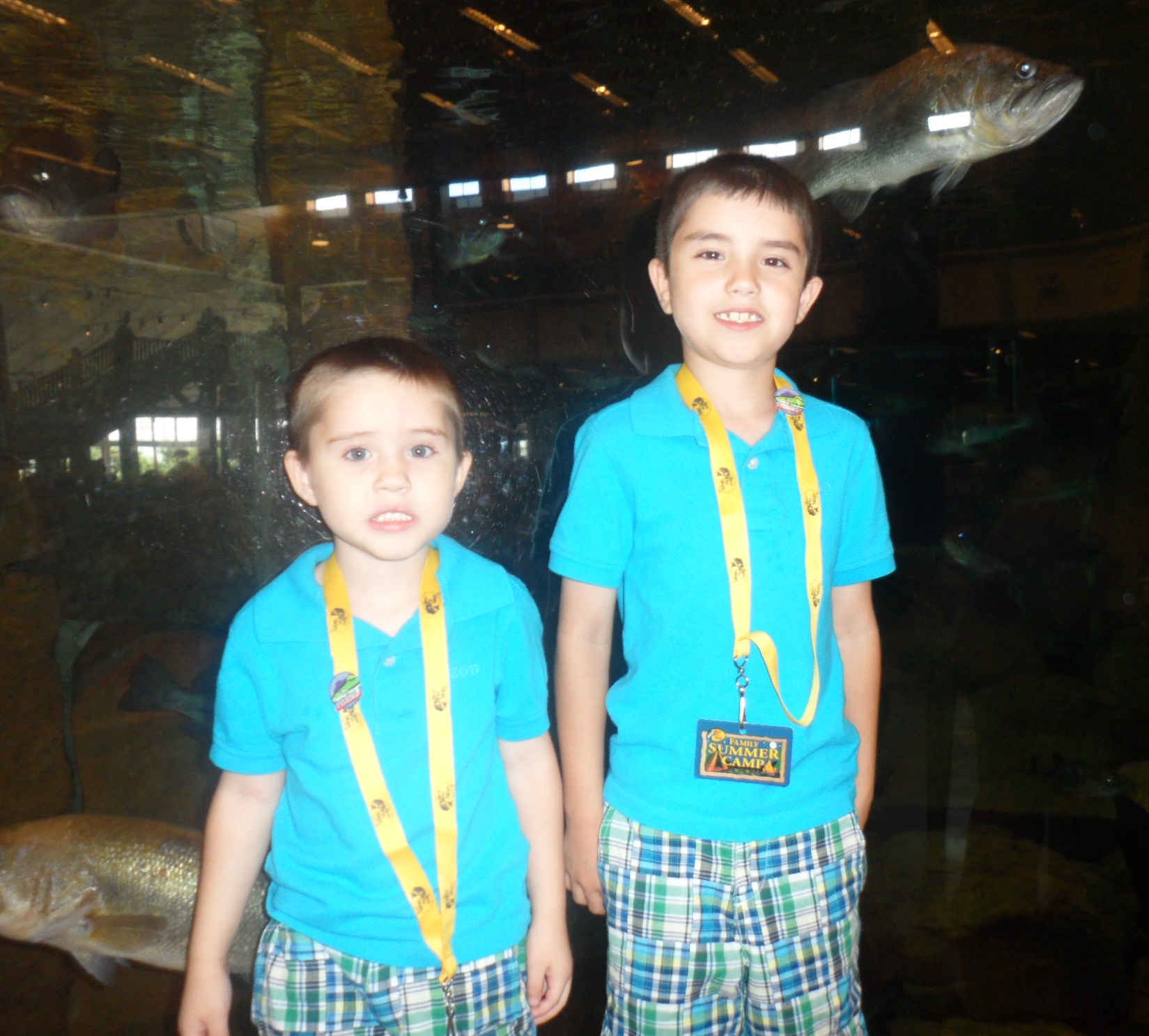 Here are the boys by the fish with their fishing pins on their lanyards.