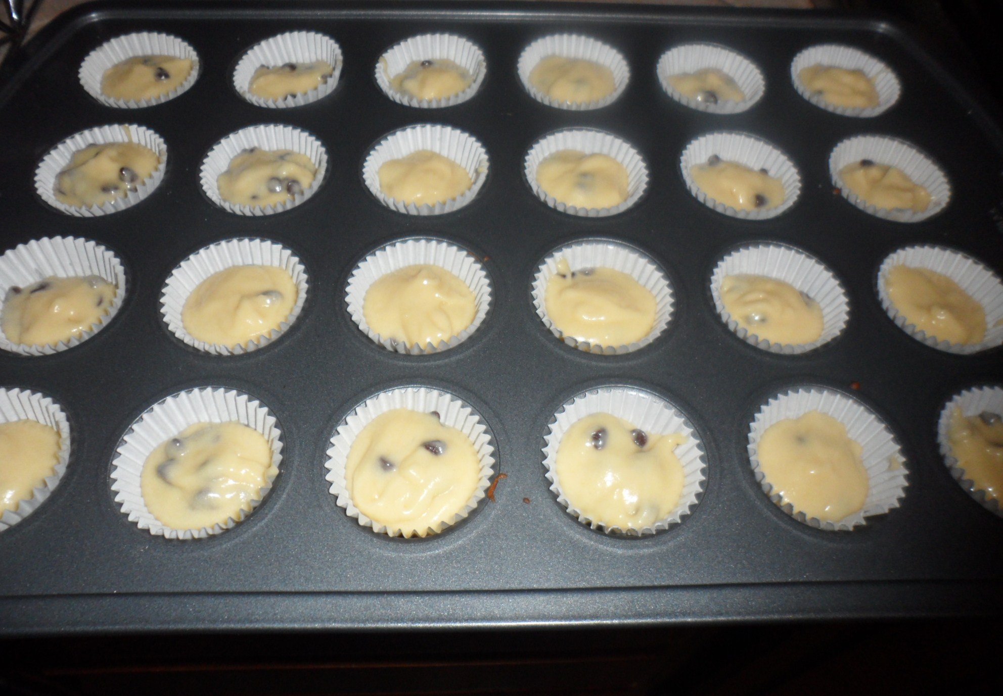 Here is the filled pan.  I had the boys put the cupcake liners in while I was beating the butter and sugar together.