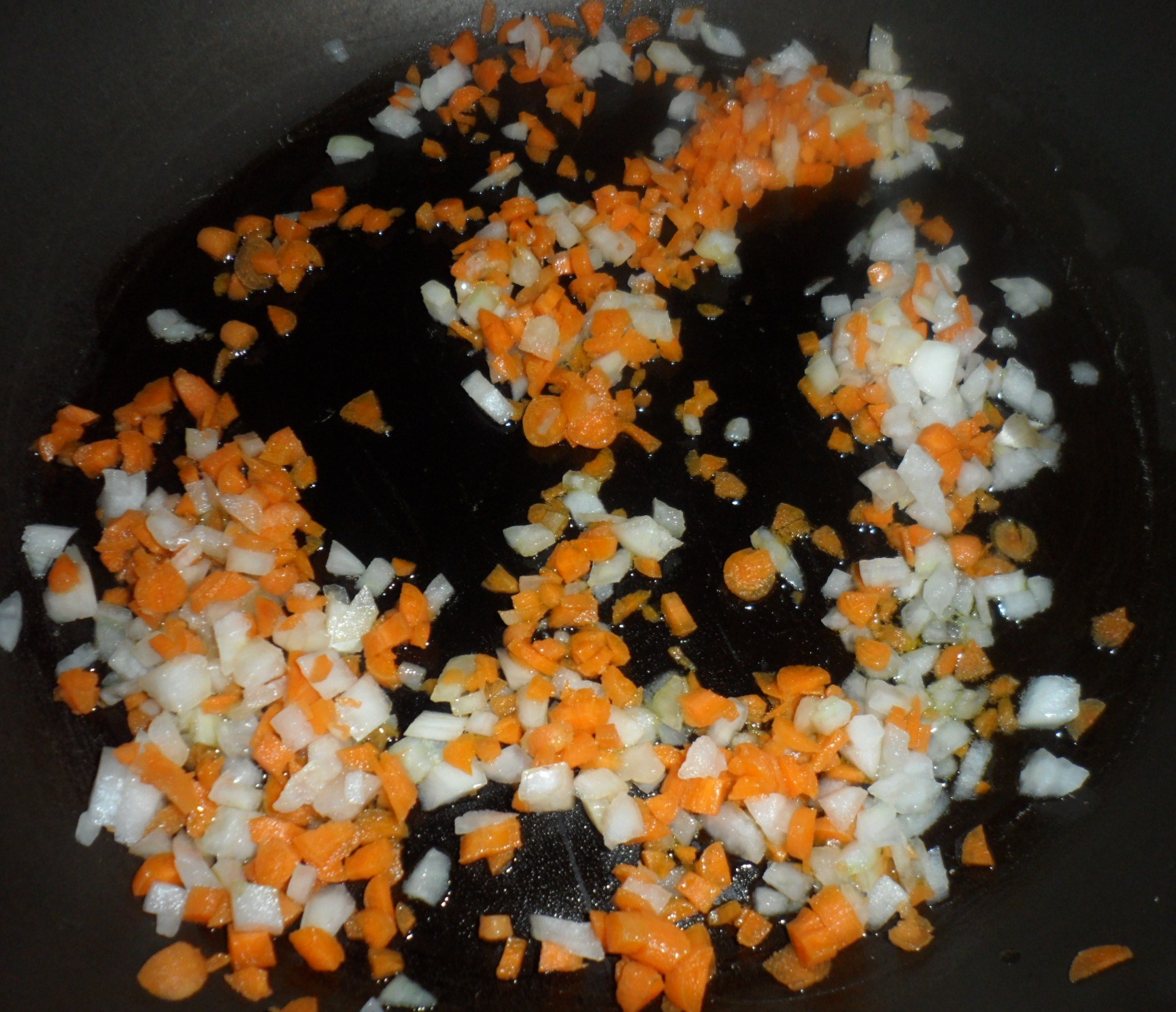 You start off by cooking some diced carrots and onions in olive oil.  Then you add in some minced garlic and then your ground turkey or beef.