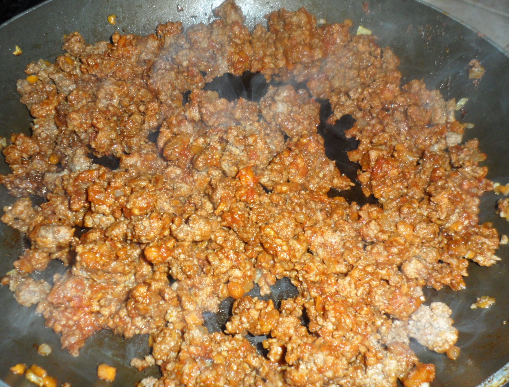 After your meat has cooked you add in some Worcestershire sauce, brown sugar, tomato paste, and chili powder.